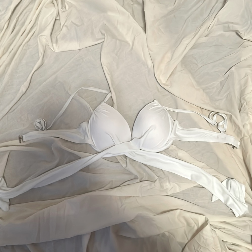 White bathing suit top, the tie crosses in the front than ties around the back.